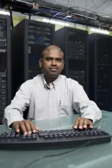 Technician Prints: Portrait of a technician working on a network server