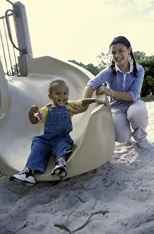 Denim Prints: Portrait of a teenage girl playing with a baby boy