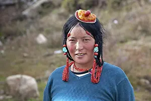Looks Into The Camera Prints: Portrait of Tibetan Khampa woman wearing traditional amber and red coral hair piece at Zhuqing