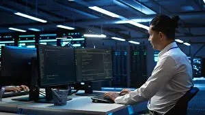 Networks Prints: Portrait of upbeat admin in data center managing servers