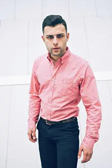 Welldressed Prints: Portrait of serious welldressed businessman standing against wall