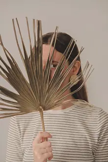 Body Parts Prints: Portrait of a woman looking through a palm leaf. Young caucasian