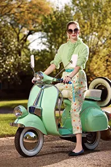Motorbike Prints: Portrait of woman sitting on vespa outside in a driveway