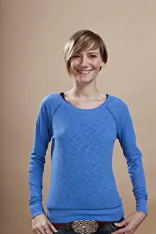 Hand On Hip Prints: Portrait of a woman smiling in anticipation, studio shot