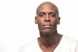 Bald Prints: Portrait of young bald African American man looking at camera with straight face