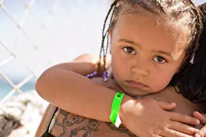 Out Door Prints: Portrait of a serious young girl getting a hug from an adult