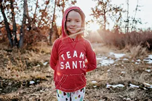 Sweater Prints: Portrait of young girl wearing a santa shirt in field with snow