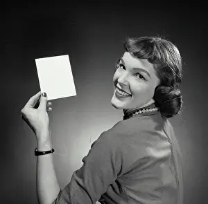 Flash Prints: Portrait of a young woman holding a blank flash card