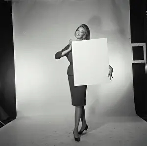 Heels Prints: Portrait of a young woman holding a blank placard