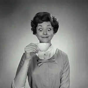 Staring Prints: Portrait of young woman holding tea cup