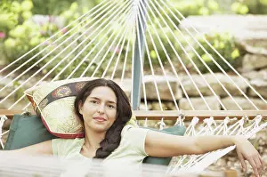 Diverse Prints: Portrait of young woman lying on hammock