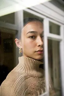 Sweater Prints: Portrait of young woman reflected in window