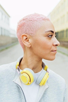 Bame Prints: Portrait of young woman with short pink hair, wearing headphones