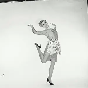 Standing On One Leg Prints: Portrait of a young woman standing on one leg