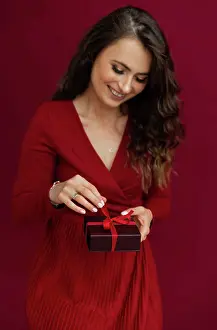 Opening Prints: Positivity emotional woman in red dress opened box with stripe