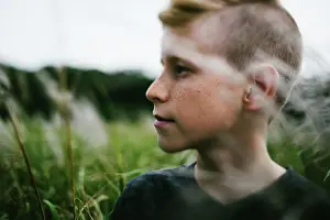 Hike Prints: Pre teenage boy outside in nature in grass field