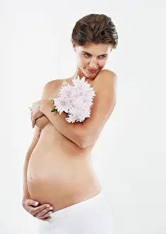 Maternity Prints: Pregnancy, abdomen and woman with flowers for motherhood on a white background in studio