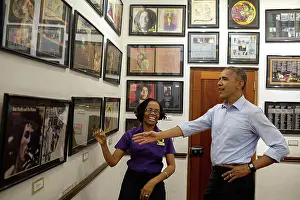 Kingston Prints: President Barack Obama looks at memorabilia with museum guide Natasha Clark at the Bob Marley Museum in Kingston