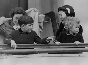 King Of Great Britain Prints: Princess Anne follows the painting finger of Prince Charles on board the new Royal yacht Britannia in Portsmouth