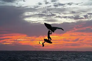 Seas Prints: Pro surfer James Jenkins jumps his wing surfer at sunset over the Pamlico Sound at Nags Head