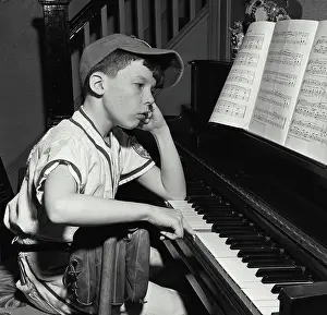 Side profile of a boy playing a piano