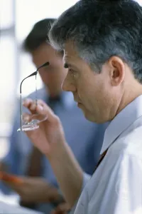Shirt And Tie Prints: Side profile of a businessman holding eyeglasses
