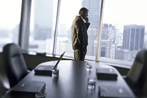 Business Suit Prints: Side profile of a businessman talking on a mobile phone