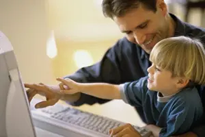 Father Prints: Side profile of a father and his son using a computer