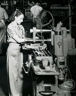 Manual Worker Prints: Side profile of a female worker working on a machine in an assembly plant
