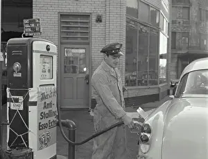 Stationary Prints: Side profile of a gas station attendant filling up a car