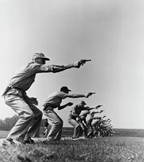 Large Group Of People Prints: Side profile of a group of policemen at a shooting range