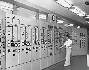 Full Length Prints: Side profile of a man operating a control panel in a gas conservation plant