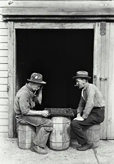 Smoking Prints: Side profile of two mature men playing checkers