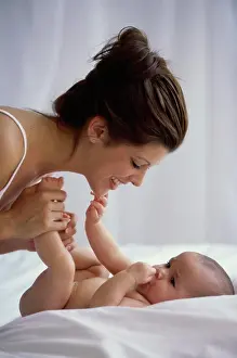 Beginnings Prints: Side profile of a mother playing with her baby boy