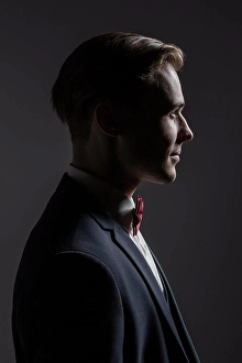 Determined Prints: Profile portrait handsome young man in suit with bow tie