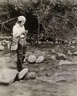 One Young Woman Only Prints: Side profile of a young woman fishing