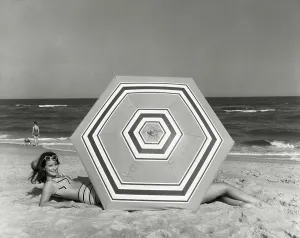 One Young Woman Only Prints: Side profile of young woman lying on beach