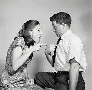 Short Prints: Side profile of a young woman pointing at a young man