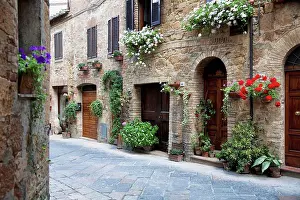 Tuscany Prints: A quaint village with flowers decorating residential buildings; Pienza, Tuscany, Italy