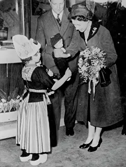 Her Majesty Prints: Queen At Ideal Home Exhibition -- The Queen receiving from 5-year-old Marijke Legerstee