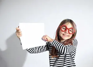 Student Prints: Quirky Kid Wearing Red Glasses Holding Up A White Piece Of Paper