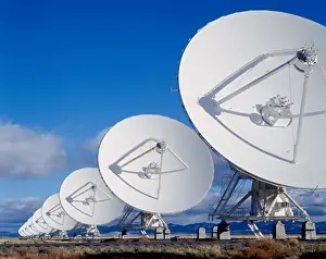 Communications Prints: Radio telescopes in a row on a landscape