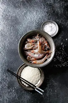 Culinary Prints: Raw whole fresh uncooked prawns shrimps on ice in vintage metal bowl with cooking ingredients above