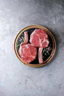 Cutting Prints: Raw uncooked black angus beef tomahawk steaks on bones served with salt
