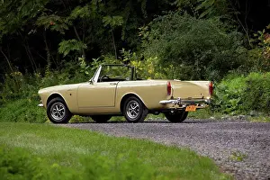 Top Down Prints: Rear 3/4 view of a yellow 1967 Sunbeam Alpine 1725 parked on a gravel forest road