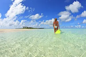 Model Release Prints: Rear view of woman with mask, fins and snorkel wading in ocean
