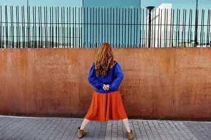 20 To 25 Years Prints: Rear view of woman standing with legs apart while facing wall