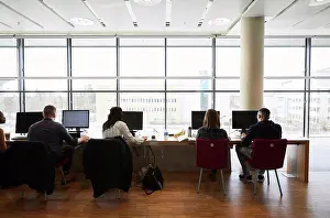 Campus Prints: Rear view of young friends using computers in university