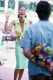 Bouquet Prints: Rear view of a young man hiding a bouquet behind his back