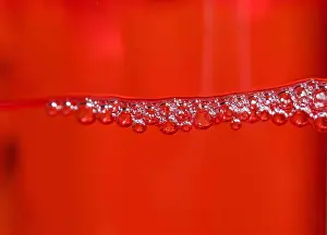 Cleaning Prints: Red detergent bubbles in macro view